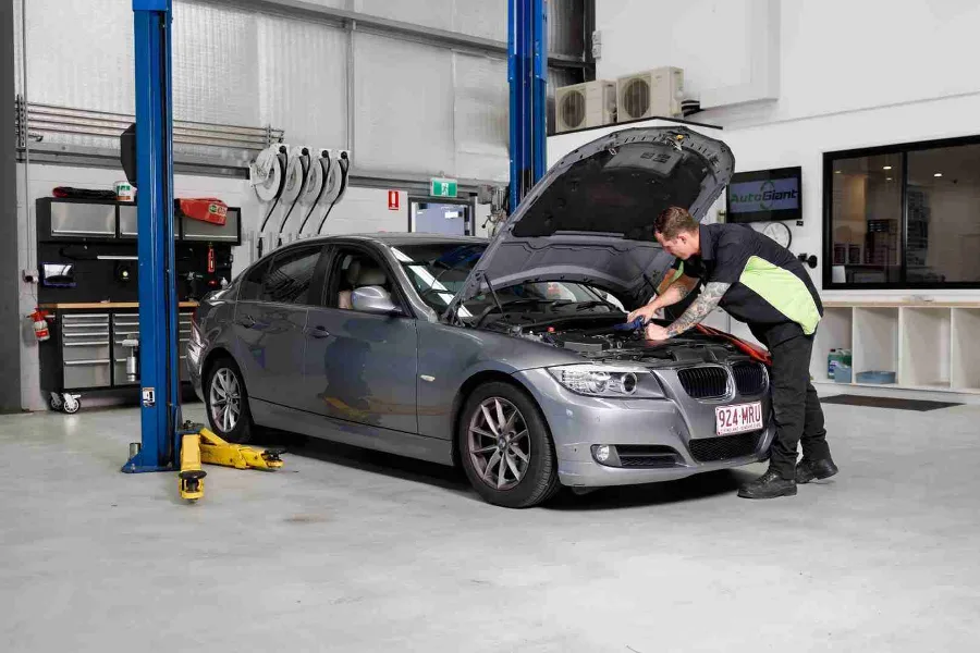 A mechanic working on a car in the AutoGiant workshop
